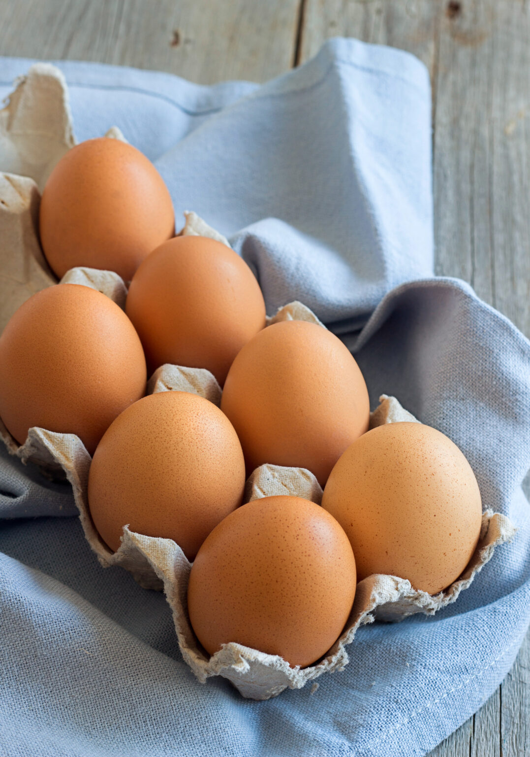 Chicken eggs in the box  on the blue napkin