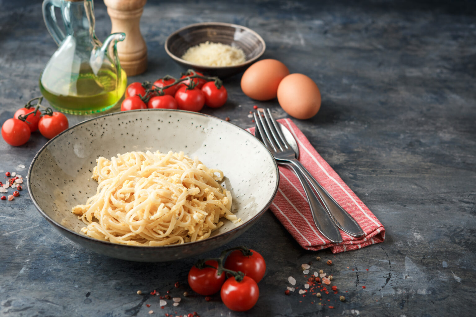 Pasta Linguine with scrambled eggs and parmesan cheese. Traditional italian cuisine.