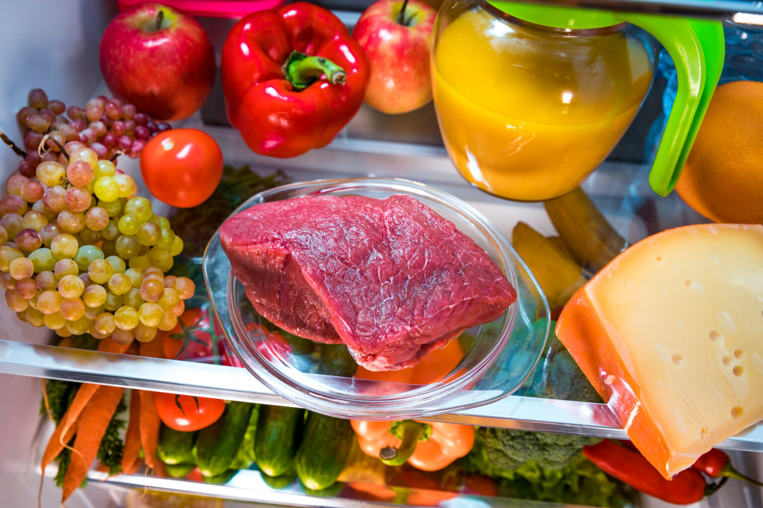 Fresh raw meat on a shelf open refrigerator