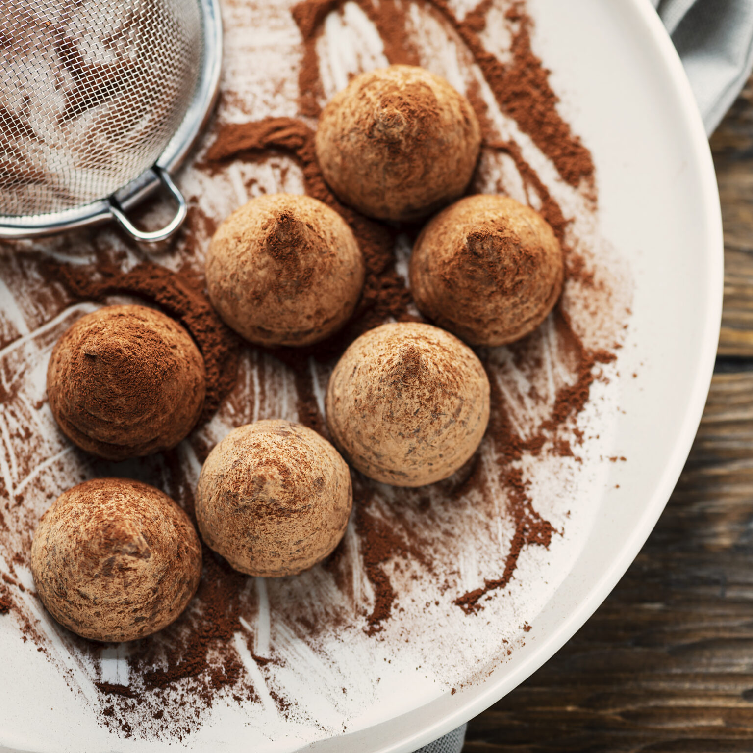 Homemade chocolate truffle on the wooden table, selective focus and square image
