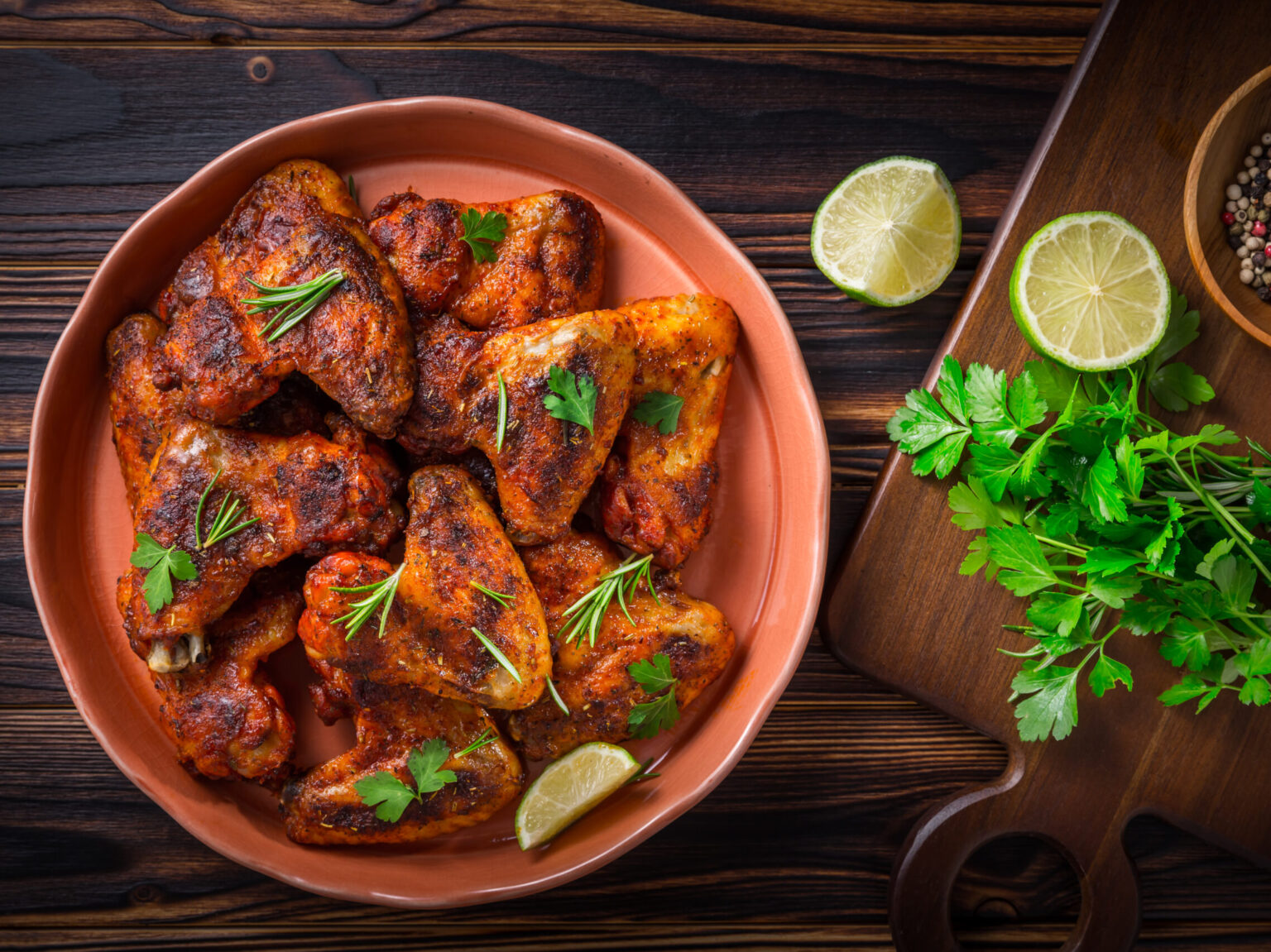 Hot and Spicey Buffalo Chicken Wings with ingredients on wooden background