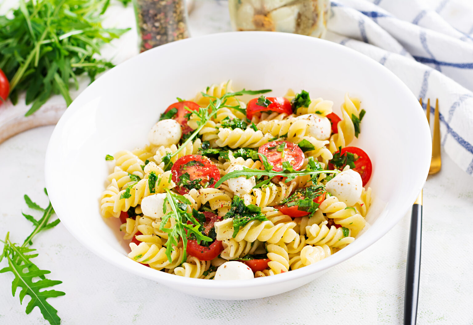 Pasta salad. Fusilli Pasta - Caprese salad with tomato, mozzarella and basil.