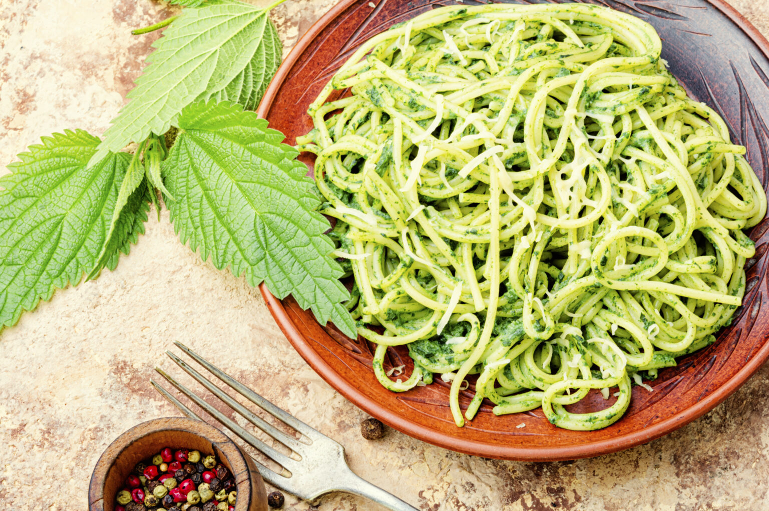 Italian traditional pasta with nettle sauce.Vegetarian green pasta with nettle leaves.