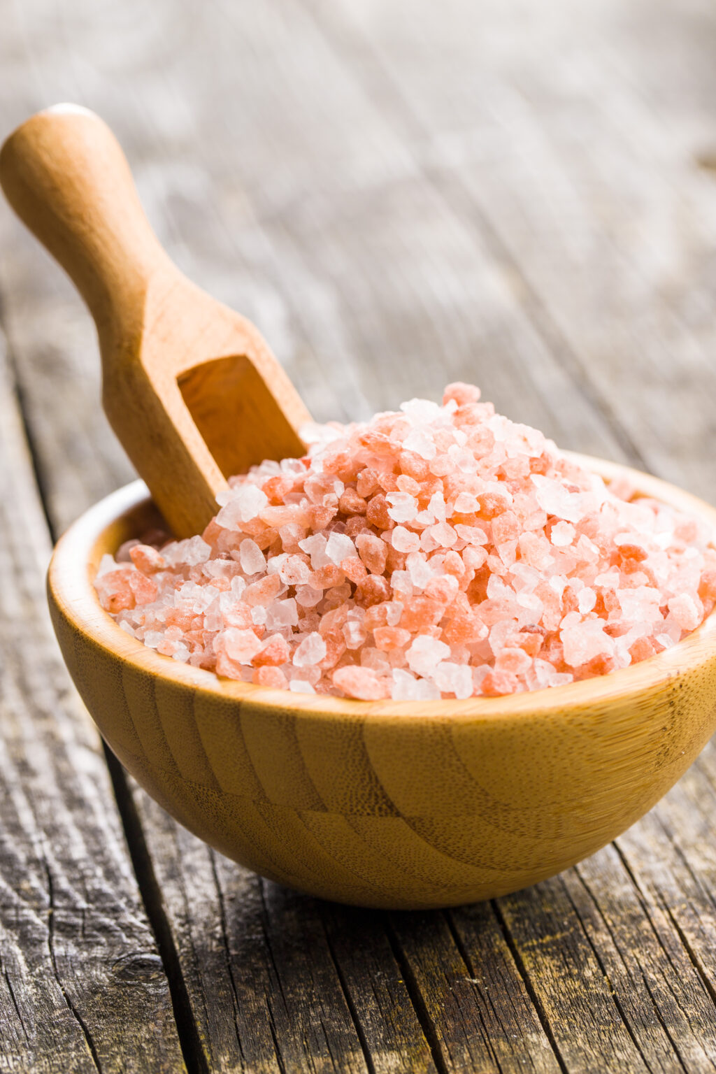 Pink himalayan salt in wooden bowl.